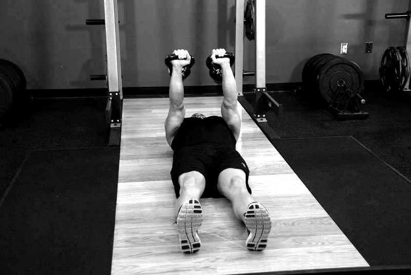 Alternating Floor Press — start position demonstration photo