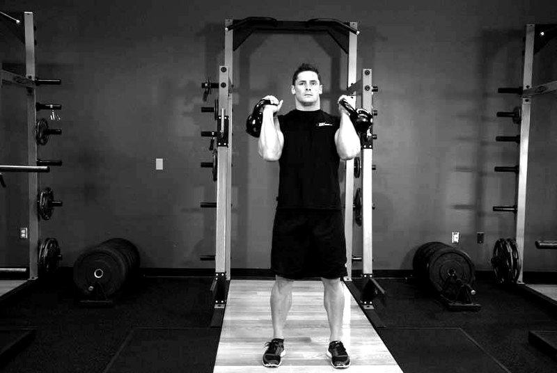 Alternating Kettlebell Press — start position demonstration photo