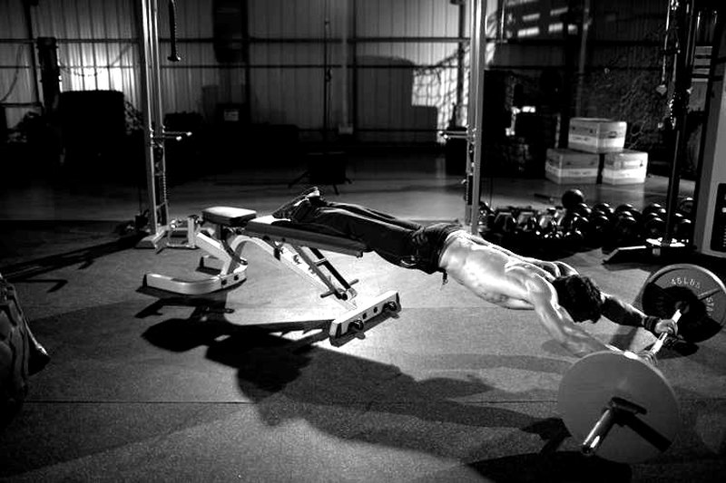 Barbell Rollout from Bench — end position demonstration photo
