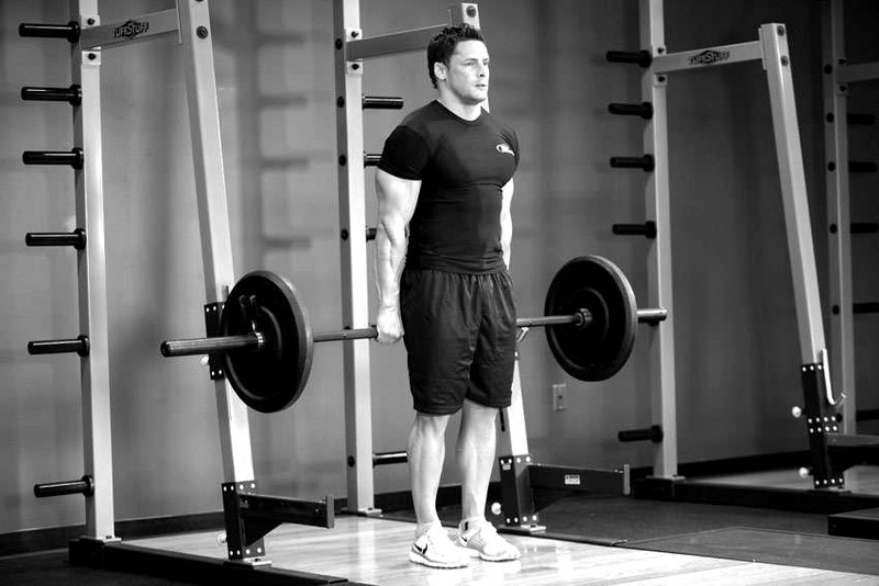 Barbell Shrug Behind The Back — start position demonstration photo