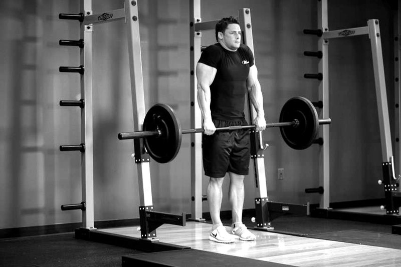 Barbell Shrug — end position demonstration photo