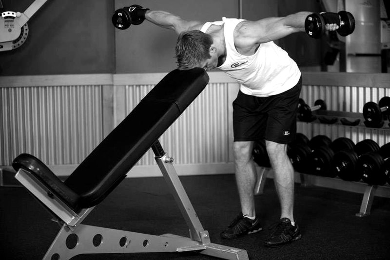Bent Over Dumbbell Rear Delt Raise With Head On Bench — end position demonstration photo