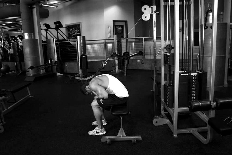 Cable Seated Crunch — end position demonstration photo