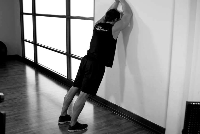 Calf Stretch Elbows Against Wall — end position demonstration photo