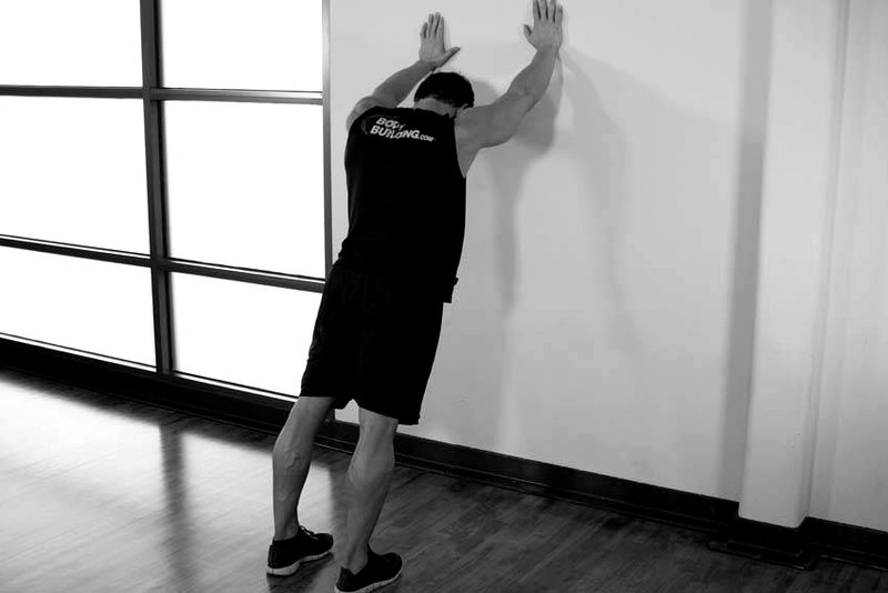 Calf Stretch Hands Against Wall — end position demonstration photo