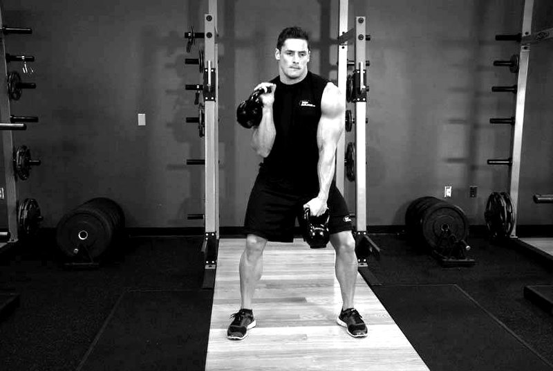 Double Kettlebell Alternating Hang Clean — end position demonstration photo