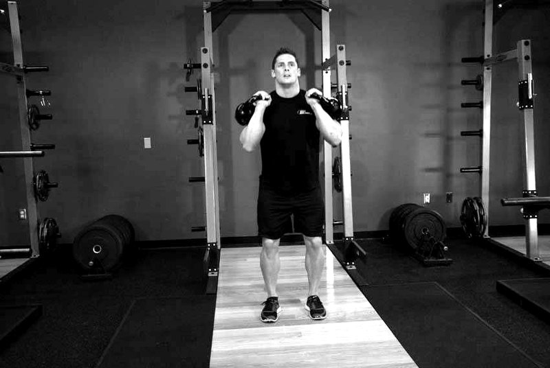 Double Kettlebell Jerk — end position demonstration photo
