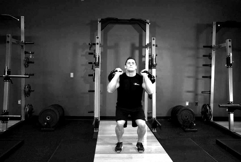 Double Kettlebell Push Press — end position demonstration photo