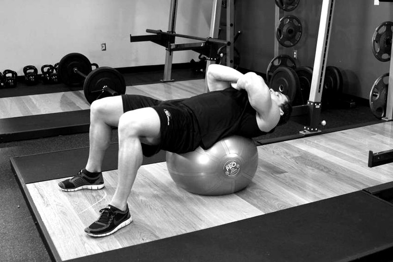 Exercise Ball Crunch — start position demonstration photo