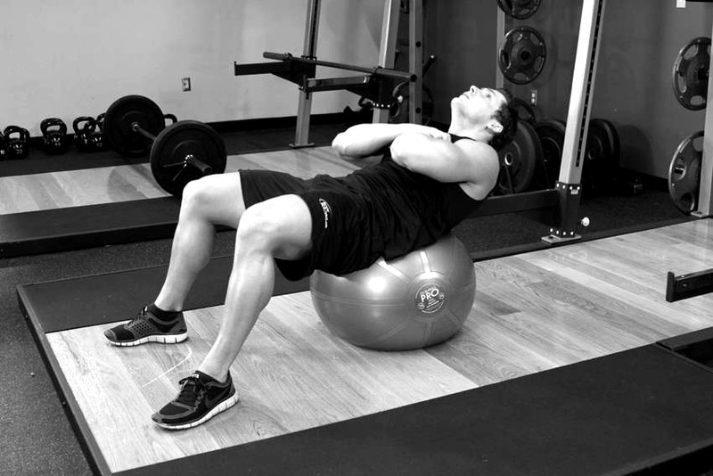 Exercise Ball Crunch — end position demonstration photo