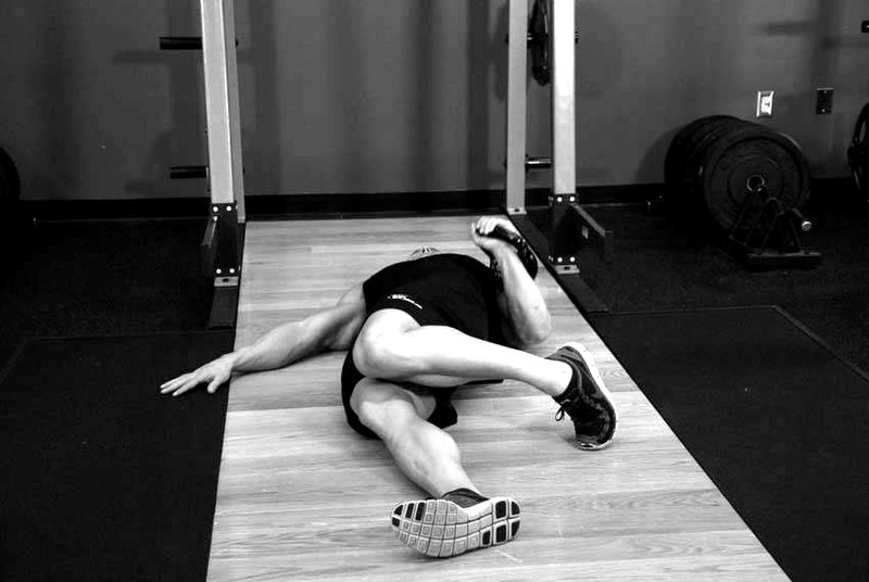 Extended Range One-Arm Kettlebell Floor Press — start position demonstration photo
