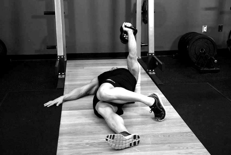Extended Range One-Arm Kettlebell Floor Press — end position demonstration photo