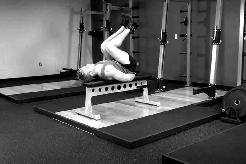 Flat Bench Leg Pull-In — start position demonstration photo
