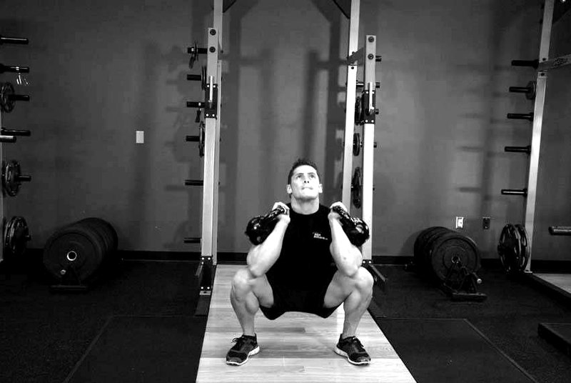 Front Squats With Two Kettlebells — end position demonstration photo