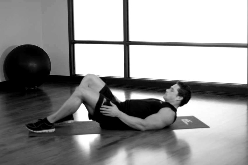 Hug Knees To Chest — start position demonstration photo
