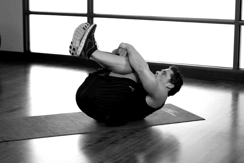 Hug Knees To Chest — end position demonstration photo