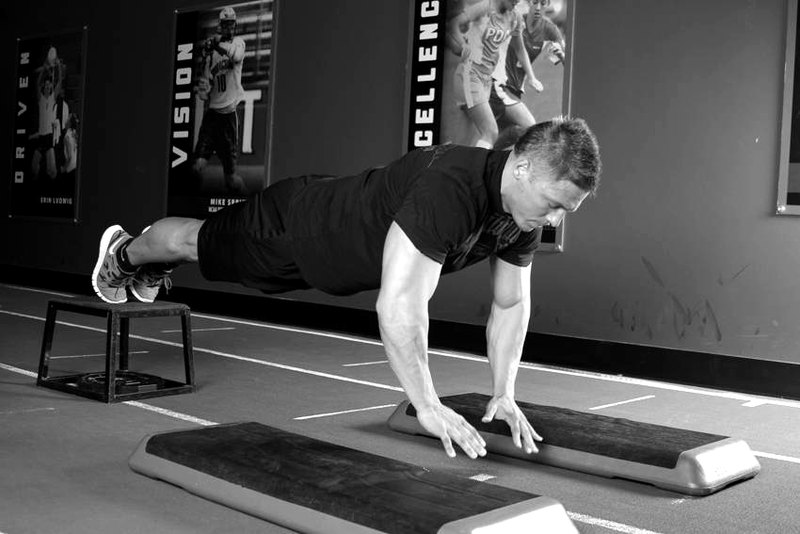 Incline Push-Up Depth Jump — end position demonstration photo