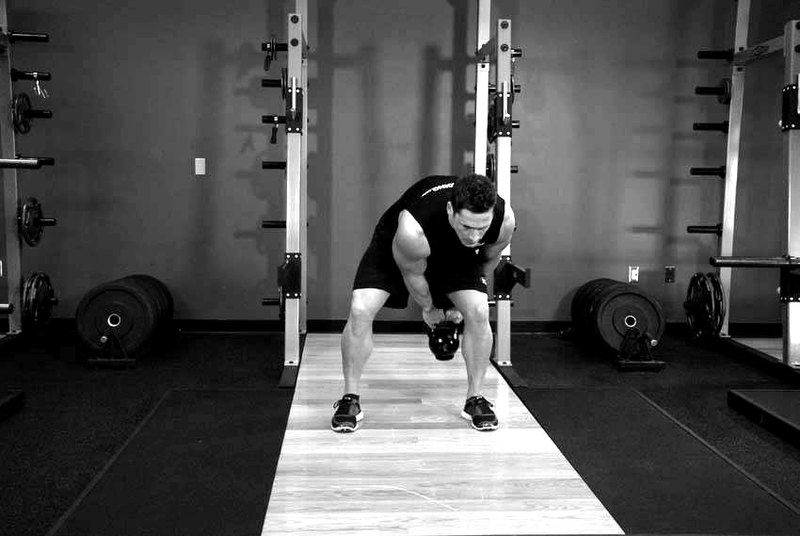 Kettlebell Pass Between The Legs — end position demonstration photo