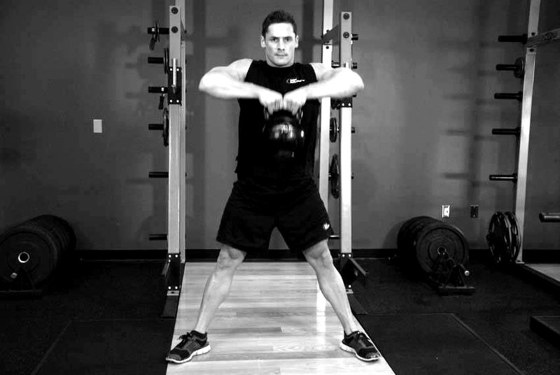 Kettlebell Sumo High Pull — end position demonstration photo