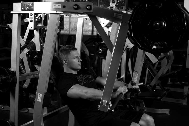 Leverage Decline Chest Press — end position demonstration photo