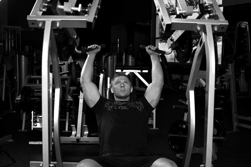 Leverage Shoulder Press — end position demonstration photo