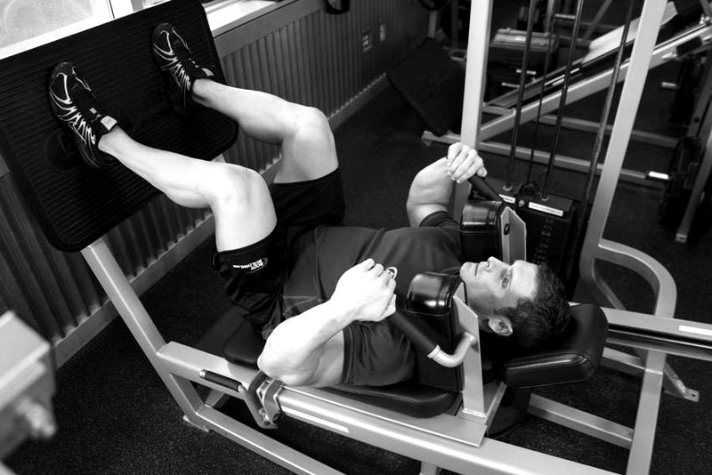 Lying Machine Squat — start position demonstration photo