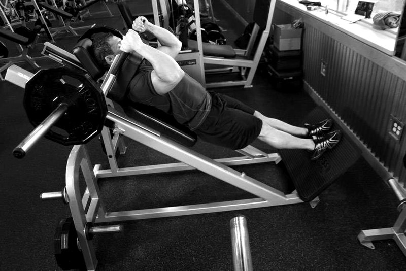 Narrow Stance Hack Squats — end position demonstration photo