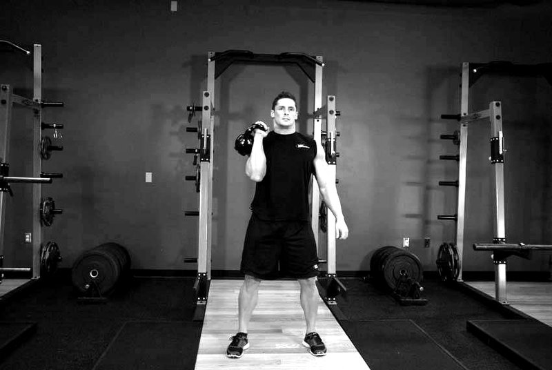 One-Arm Kettlebell Clean and Jerk — end position demonstration photo