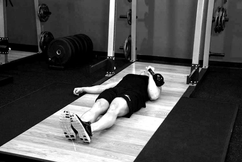 One-Arm Kettlebell Floor Press — start position demonstration photo