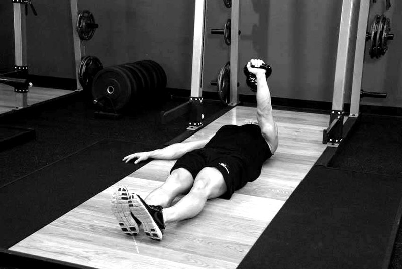 One-Arm Kettlebell Floor Press — end position demonstration photo