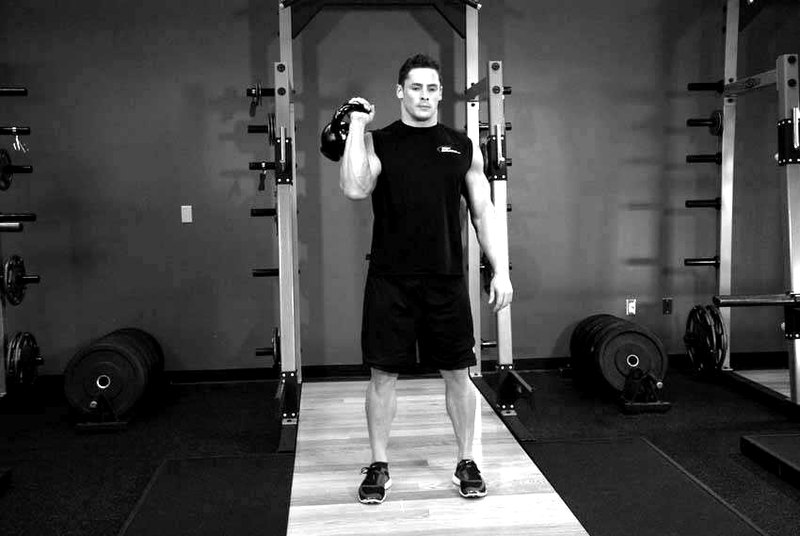 One-Arm Kettlebell Split Jerk — start position demonstration photo