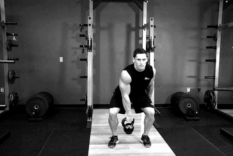 One-Arm Kettlebell Split Snatch — end position demonstration photo