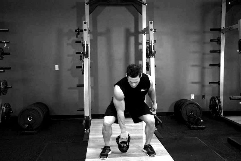 One-Arm Open Palm Kettlebell Clean — start position demonstration photo
