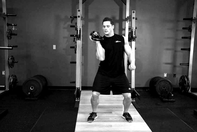 One-Arm Open Palm Kettlebell Clean — end position demonstration photo