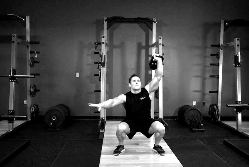 One-Arm Overhead Kettlebell Squats — end position demonstration photo