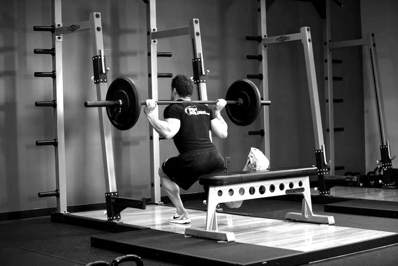 One Leg Barbell Squat — end position demonstration photo