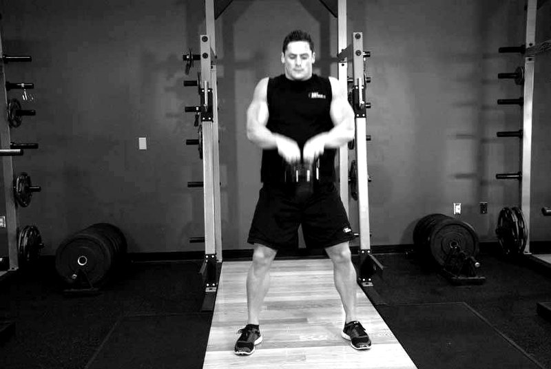 Open Palm Kettlebell Clean — end position demonstration photo