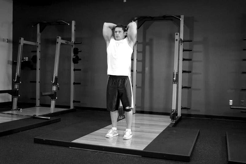 Overhead Dumbbell Triceps Extension — end position demonstration photo