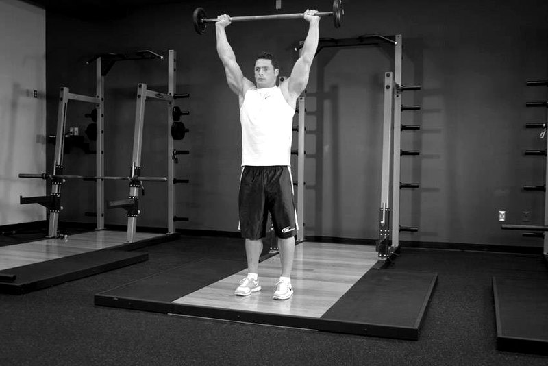 Standing Overhead Press — end position demonstration photo