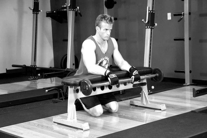 Palms-Down Wrist Curl Over A Bench — start position demonstration photo