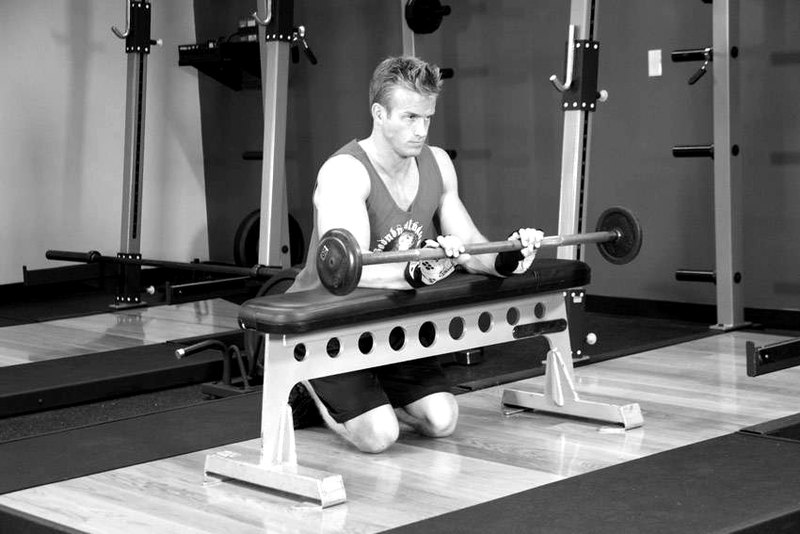 Palms-Down Wrist Curl Over A Bench — end position demonstration photo
