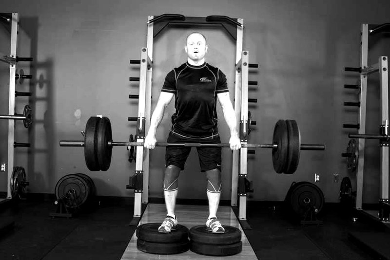 Romanian Deadlift from Deficit — start position demonstration photo