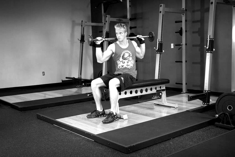 Seated Barbell Twist — end position demonstration photo