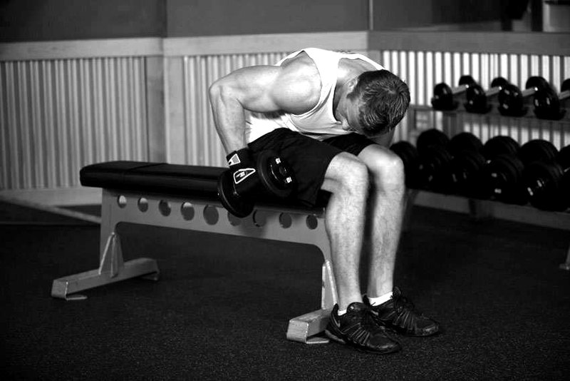 Seated Bent-Over One-Arm Dumbbell Triceps Extension — start position demonstration photo