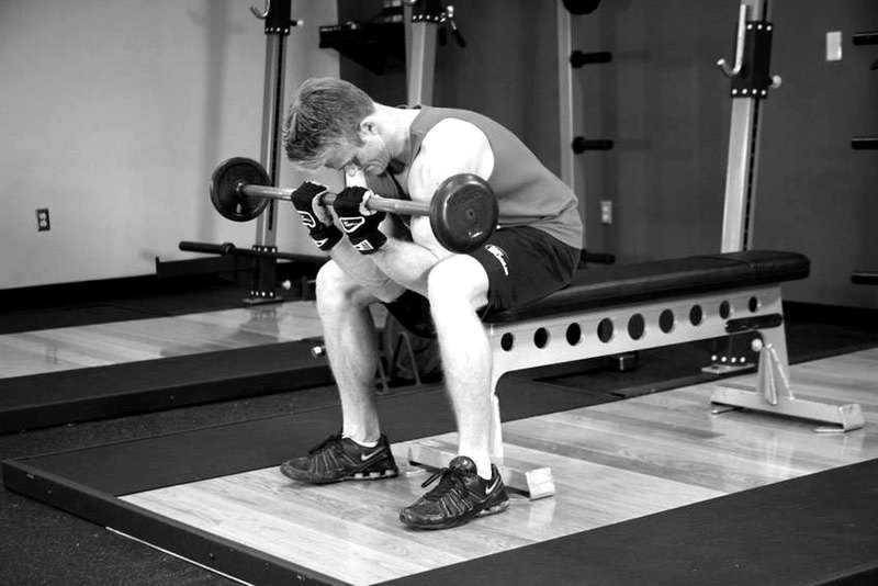 Seated Close-Grip Concentration Barbell Curl — end position demonstration photo