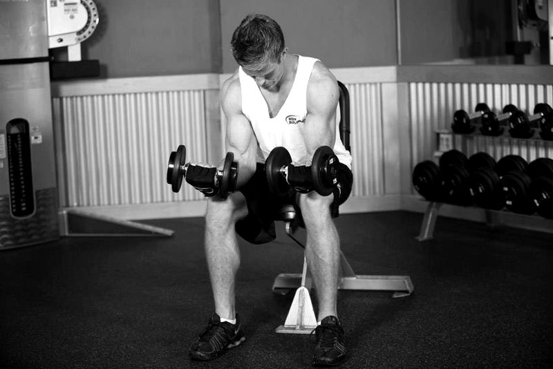 Seated Dumbbell Palms-Up Wrist Curl — end position demonstration photo