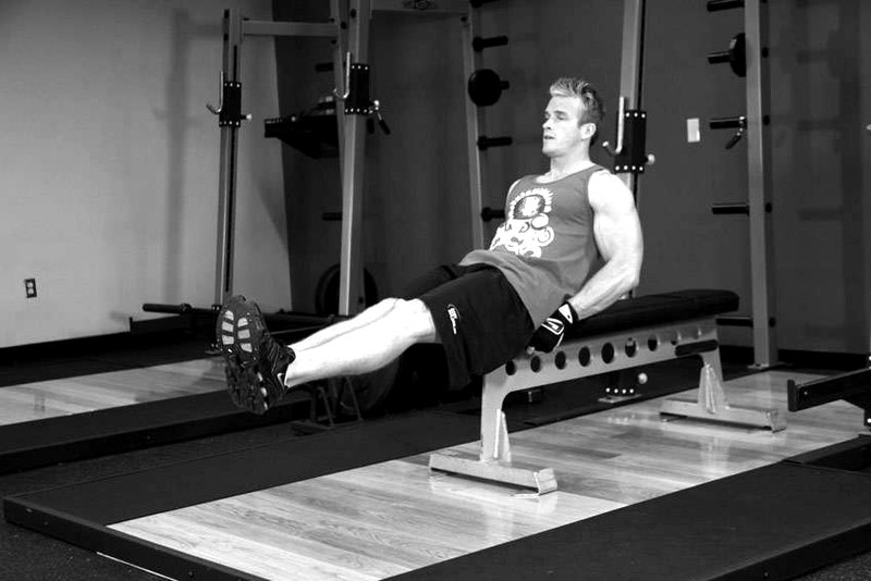 Seated Flat Bench Leg Pull-In — start position demonstration photo