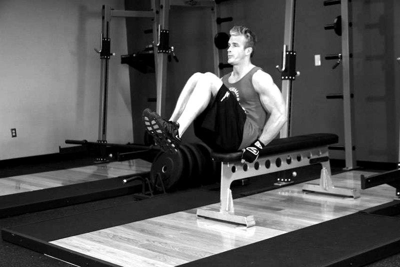 Seated Flat Bench Leg Pull-In — end position demonstration photo