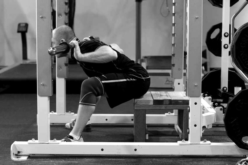 Seated Good Mornings — end position demonstration photo