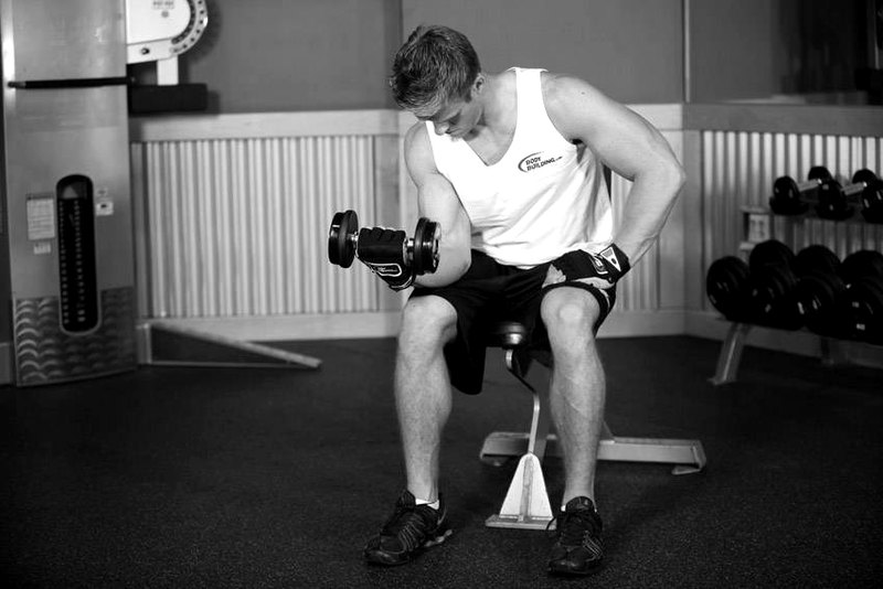 Seated One-Arm Dumbbell Palms-Up Wrist Curl — end position demonstration photo